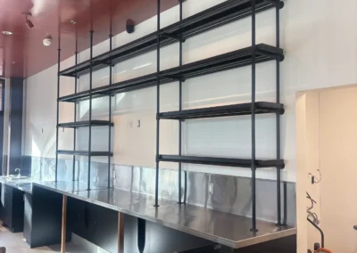 Custom steel pipe shelving and stainless counter fabricated by Johnson Iron for Dopo Pizza, Truckee CA